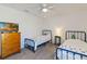 Bright bedroom with two beds, dresser, and a ceiling fan at 1212 Bear Oak Ln, Deland, FL 32720
