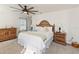 Bright bedroom features a ceiling fan, neutral carpet, and wood furniture at 1212 Bear Oak Ln, Deland, FL 32720