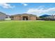 Community entrance with a decorative gate, stone accents, and a grassy area, leading to a playground at 1212 Bear Oak Ln, Deland, FL 32720