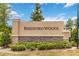 Entrance sign for Beresford Woods community, featuring stone accents, manicured landscaping, and clear signage at 1212 Bear Oak Ln, Deland, FL 32720