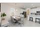 Open-concept dining area with modern light fixture and view of kitchen at 1212 Bear Oak Ln, Deland, FL 32720