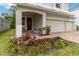 Charming front porch with comfortable seating and colorful flower garden at 1212 Bear Oak Ln, Deland, FL 32720