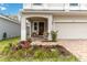 Inviting covered front porch with seating and decorative plants at 1212 Bear Oak Ln, Deland, FL 32720