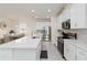Contemporary kitchen featuring stainless steel appliances, large island with seating, quartz countertop, and tile backsplash at 1212 Bear Oak Ln, Deland, FL 32720