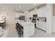 Bright kitchen featuring a large island with seating, stainless appliances, white cabinetry, and tile flooring at 1212 Bear Oak Ln, Deland, FL 32720