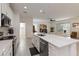 Open kitchen featuring white cabinets, an island with a sink, and modern appliances at 1212 Bear Oak Ln, Deland, FL 32720