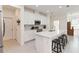 Bright kitchen with an island, seating, stainless appliances, white cabinets, and a stylish tile backsplash at 1212 Bear Oak Ln, Deland, FL 32720