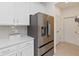 Updated kitchen featuring stainless steel refrigerator, sleek countertops, and modern tile backsplash for stylish cooking at 1212 Bear Oak Ln, Deland, FL 32720