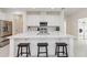 Beautiful kitchen featuring stainless appliances, a large island with seating, white cabinets, and modern backsplash at 1212 Bear Oak Ln, Deland, FL 32720