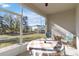 Enclosed lanai with comfortable seating and a view of the backyard at 1212 Bear Oak Ln, Deland, FL 32720