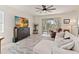 Bright living room features a ceiling fan, a rug, large windows and sliding glass doors to the outside screened-in area at 1212 Bear Oak Ln, Deland, FL 32720
