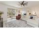 Bright living room with fan and screened patio offers lots of light and easy access to outdoor living at 1212 Bear Oak Ln, Deland, FL 32720