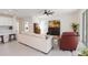 Bright living area featuring tile floors, a comfortable sofa, ceiling fan, and an open flow into the modern kitchen at 1212 Bear Oak Ln, Deland, FL 32720