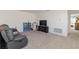Carpeted loft area providing flexible space with a large entertainment center and neutral wall color at 1212 Bear Oak Ln, Deland, FL 32720