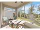 Relaxing screened-in patio featuring tile flooring, ceiling fan, comfortable seating, and a lovely view of the backyard at 1212 Bear Oak Ln, Deland, FL 32720