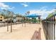Community playground area with swings, slide, and covered play equipment on a sand base and with neighborhood views at 1212 Bear Oak Ln, Deland, FL 32720