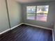 This bedroom features wood-look flooring and plenty of natural light from the double windows at 1219 Dewey Ave, Orlando, FL 32808