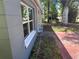 The exterior of the house shows a long side porch and red-tinted driveway at 1219 Dewey Ave, Orlando, FL 32808