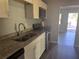 Updated kitchen with stainless steel oven and microwave, gray countertops, and white cabinets at 1219 Dewey Ave, Orlando, FL 32808