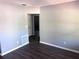 Bright living room features fresh paint, gray floors and an adjacent doorway at 1219 Dewey Ave, Orlando, FL 32808