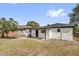 An exterior view of a home with a backyard and a covered patio area at 1240 Moton Ave, Sanford, FL 32771