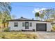 Charming single-story home with stucco exterior, dark trim, and a well-manicured front yard at 1240 Moton Ave, Sanford, FL 32771