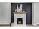 Close-up of a modern fireplace with a brick surround, wooden mantel, and a cozy fire burning at 1240 Moton Ave, Sanford, FL 32771