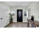 Inviting foyer with a decorative front door, stylish console table, and luxury vinyl plank flooring at 1240 Moton Ave, Sanford, FL 32771