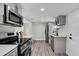 Modern kitchen with stainless steel appliances, white countertops, and stylish black fixtures at 1240 Moton Ave, Sanford, FL 32771