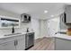 Well-lit kitchen featuring stainless steel appliances, white countertops, and luxury vinyl plank flooring at 1240 Moton Ave, Sanford, FL 32771