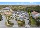 Aerial view of a grand estate featuring a meticulously landscaped front yard and multi-car garage at 1297 Grand Traverse Pkwy, Reunion, FL 34747