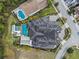 Overhead shot of the roof, pool, and manicured landscape surrounding the property at 1297 Grand Traverse Pkwy, Reunion, FL 34747