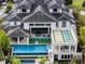 Aerial view of a luxurious two-story home showcasing a pristine pool, outdoor lounge and modern architectural details at 1297 Grand Traverse Pkwy, Reunion, FL 34747