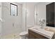 Modern bathroom featuring a glass enclosed shower, a dark wood vanity, and white subway tile at 1297 Grand Traverse Pkwy, Reunion, FL 34747