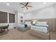 Bright bedroom showcasing two beds, modern decor, and a comfortable setting at 1297 Grand Traverse Pkwy, Reunion, FL 34747