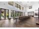 Elegant dining area featuring high ceilings, large windows, and a long table ideal for large gatherings and entertaining at 1297 Grand Traverse Pkwy, Reunion, FL 34747