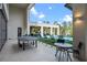 Spacious outdoor patio featuring a ping pong table and lounge chairs overlooking the pool and manicured lawn at 1297 Grand Traverse Pkwy, Reunion, FL 34747