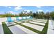 Stylish pool deck featuring modern sun loungers arranged on a geometric turf pattern at 1297 Grand Traverse Pkwy, Reunion, FL 34747