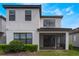 Exterior elevation with covered screened patio and well-maintained landscaping at 1344 Blue Stem Lane, Winter Park, FL 32792