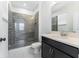 Bathroom featuring tiled walk-in shower with glass door and vanity at 1344 Blue Stem Lane, Winter Park, FL 32792