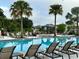 Relaxing community pool featuring lounge chairs and shaded seating areas for leisure and socializing at 1344 Blue Stem Lane, Winter Park, FL 32792