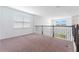 Hallway with carpet, white walls, a window, and railing overlooking the first floor at 1344 Blue Stem Lane, Winter Park, FL 32792