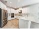 Bright kitchen with white cabinets, stainless steel appliances, and stone countertops at 1344 Blue Stem Lane, Winter Park, FL 32792