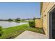 A serene backyard view featuring a tranquil lake and lush green space, creating a peaceful outdoor oasis at 13441 Starry Night Ct # 9, Orlando, FL 32824