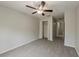 This bedroom features carpet flooring, ceiling fan with light, and closet space at 13441 Starry Night Ct # 9, Orlando, FL 32824