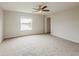 Spacious carpeted bedroom with a ceiling fan and a window overlooking the water at 13441 Starry Night Ct # 9, Orlando, FL 32824