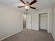 This bedroom features carpet flooring, ceiling fan with light, and closet space at 13441 Starry Night Ct # 9, Orlando, FL 32824