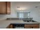 A view from the kitchen, showing an open layout to the living space and dining area at 13441 Starry Night Ct # 9, Orlando, FL 32824