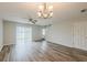 Spacious living room with wood floors, plenty of natural light, and modern ceiling fan at 13441 Starry Night Ct # 9, Orlando, FL 32824