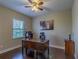 Cozy bedroom with hardwood floors, desk, and plenty of natural light at 14031 Jomatt Loop, Winter Garden, FL 34787